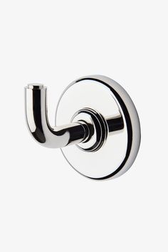 a chrome toilet roll holder on a white wall with the handle extended to it's left side