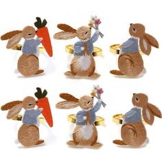 four brown and white rabbits with carrots on their backs, one holding a flower in its hand