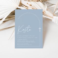 a card with the word kosta on it next to some palm fronds