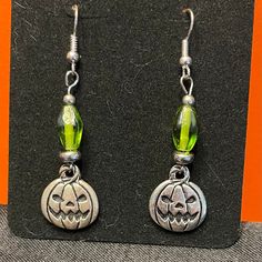 Hand Crafted Halloween Earrings With Spooky Jack O Lantern Charms And Green Glass Beads. French Wire, 2" Drop. Brand New! Halloween Hypoallergenic Metal Jewelry, Hypoallergenic Jewelry For Halloween Party, Nickel-free Silver Earrings For Halloween, Silver Metal Earrings For Halloween, Green Halloween Party Earrings, Silver Ear Wire Earrings For Halloween, Green Novelty Earrings For Halloween, Green Halloween Dangle Earrings, Green Earrings For Halloween Gift