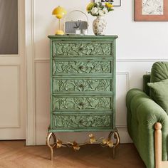 a green chest of drawers sitting next to a green couch