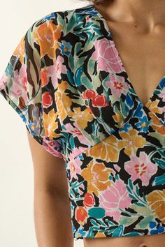 Floral-print chiffon blouse. V neckline. Short kimono sleeves. Open back with tie closure. Smocked elastic-back waist. Cropped length. Sleeveless lining. Relaxed fit. 100% Polyester. Imported. Designed in LA. Model wears size S. V-neck Blouse With Smocked Bodice For Vacation, V-neck Blouse With Smocked Back For Vacation, Chiffon V-neck Blouse For Vacation, V-neck Chiffon Blouse For Vacation, Floral Print Chiffon V-neck Top, Chic Multicolor Chiffon Blouse, Summer Floral Print Blouse With Kimono Sleeves, Summer Blouse With Floral Print And Kimono Sleeves, Floral Print Blouse With Kimono Sleeves For Summer