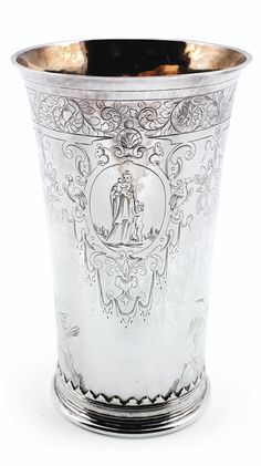 a silver cup with an ornate design on it