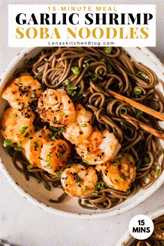 a white bowl filled with shrimp and noodles next to chopsticks on the side