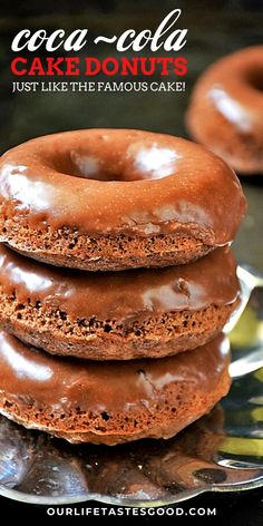 three chocolate donuts stacked on top of each other in front of the words, coca cola cake doughnuts just like the famous cake