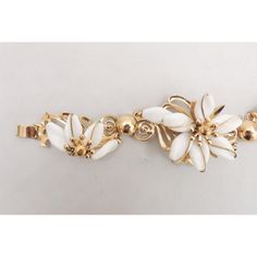 This is part of Chairish’s Costume Jewelry assortment.  Rare 1950s goldtone white resin flowers with a full flower in the middle and two half flowers on the sides ornate bracelet with fold over clasp. Marked "Napier" with no copyright symbol. Measures: 7 1/4 inches by 1 3/4 inches wide. Condition: Very good; some light goldtone wear, most noticeable on the clasp.  Please reference the measurements noted in the description above for the best approximate dimensions. Please reach out to the seller Vintage White Bracelets For Wedding, White Flower Bracelets For Formal Occasions, Formal White Flower Bracelet, 14k Gold White Flower-shaped Jewelry, Hallmarked Yellow Gold Flower Jewelry, Retro White Flower Jewelry, Vintage White Flower Bracelets, Formal White Flower-shaped Bracelet, Formal White Flower-shaped Bracelets