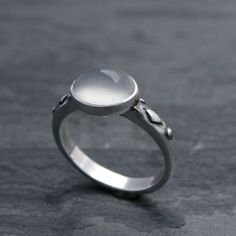 Luminous oval moonstone set in solid sterling silver on a solid sterling silver ring band.Cat eye moonstone gemstone is approximately 3/8" x 1/4" Modern moonstone is a birthstone for June. It's associated with the zodiac sign of Gemini. Moonstone is thought to bring good luck and fortune.This ring will be made to order in your size. Please select your size from the drop down menu.For more rings:https://www.etsy.com/shop/KiraFerrer?ref=hdr_shop_menu&section_id=5254786To see my entire collecti Aquamarine Stacking Ring, Silversmith Rings, Silver Ring Band, Moonstone Ring Sterling Silver, Sterling Silver Stacking Rings, Sterling Silver Rings Bands, Silver Stacking Rings, Silver Work, Ring Oval