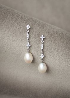 The Montpellier pearl bridal earrings are dainty and sophisticated, with its sparkly Art Deco inspired details and natural freshwater pearls. These pearl drops are the perfect detail to adorn your ears and beautifully suit classic, bohemian, vintage style and traditional bridal looks. Light on the ears, the mid-length drop will frame your neck and face, adding the perfect amount of sparkle and shimmer without taking away from the rest of your look. * DETAILS * > Freshwater pearls, cubic zirconia Wedding Earrings Pearl, Floral Wedding Veils, Pearl Wedding Earrings, Pearl Bridal Earrings, Contemporary Bridal, Crystal Bridal Earrings, Pearl Bridal Jewelry, Pearl Earrings Wedding, Wedding Earrings Drop