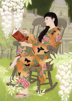 a woman sitting on a rocking chair reading a book in front of flowers and a building