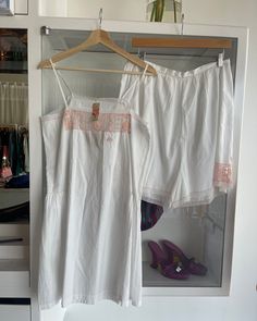 Absolutely stunning and rare lingerie set from the 1920s. In crisp white cotton with pink embroidery and delicate netting. Very Art Deco. "TJ" monogramming on the top. Gathering at the sides of the shorts & waist closed at back with small buttons.  * Appears to never have been worn and is in perfect condition Top Bust: 36" Waist: 38" Hips: 38" Length: 29" Shorts Waist: 31" Hips: 40" Inseam: 17" Length:  Suggested sizing: medium to large  ---- All vintage items have been described and dated to th Feminine White Sets For Summer, White Feminine Summer Sets, Feminine White Summer Sets, White Lace Trim Sets For Daywear, White Lace Trim Sets For Spring, Vintage White Sets For Summer, Vintage Summer Daywear Sets, Vintage White Summer Sets, White Vintage Cotton Sets