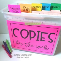 a pink sign that says copies for the week next to some markers and pencils