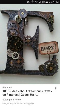 the letter e is made out of metal and has gears attached to it with a clock