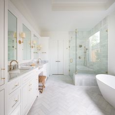 a white bathroom with two sinks and a bathtub