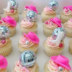 cupcakes decorated with pink and silver decorations