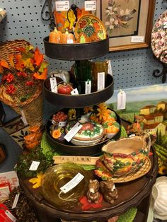 three tiered trays filled with food on top of a table in a store