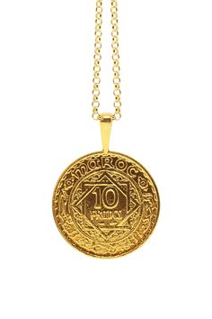 The MOROCCO Coin Necklace is handcrafted based on an authentic antique Moroccan coin with precious metals using the traditional lost-wax casting technique. The coin features beautifully rendered designs and islamic text reading Maroc and Empire Cherifien. The coin was minted in France in 1947 under the reign of Mohammed V during the time of French rule in Morocco. It features the numbers 1366, which is equivalent to the year of 1947 in the Islamic Calendar. It was in this year that Mohammed V, a Symbolic Brass Coin Necklace, Luxury Brass Coin Necklace, Vintage Brass Coin Necklaces, Moroccan Coin Necklace, Silver Tarnish-resistant Brass Coin Necklace, African Gold, Islamic Calendar, Lost Wax Casting, Wax Casting