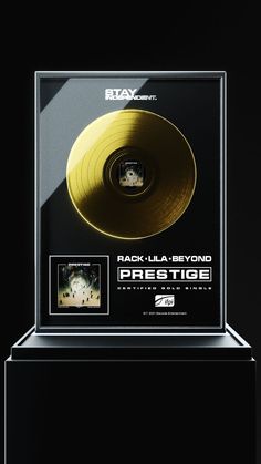 a black and white photo of a gold record in a glass case with the words kamika - azi on it