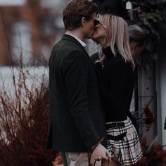 a man and woman kissing on the street