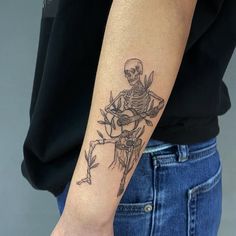 a person with a skeleton tattoo on their arm