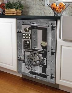 an old fashioned stove in the middle of a kitchen with white cabinets and wood floors