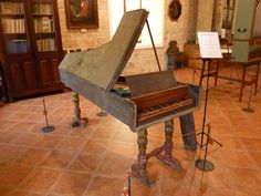 an old piano sitting in the middle of a room