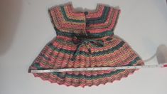 This dress is made from yarn by knitting with needles by hand. Handmade Fitted Pink Dress, Cute Fitted Knit Dress, Cute Multicolor Winter Dresses, Cute Handmade Pink Dress, Cute Pink Knitted Dress, Hand Knitted Cotton Dresses In Cute Style, Hand Knitted Cute Cotton Dresses, Hand-knitted Cotton Dresses In Cute Style, Cute Hand Knitted Cotton Dresses