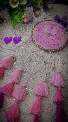 a table topped with pink tassels and decorations