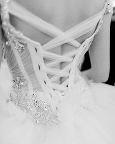 black and white photograph of a woman wearing a wedding dress with beading on it