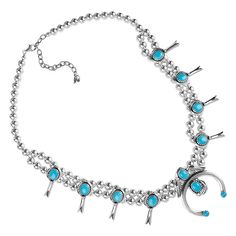 This naturally colorful Southwestern Sterling Silver and Turquoise statement necklace features a center with oval Blue Turquoise cabochon gemstones set in serrated bezels, which accentuate the stations along the double row of polished beads. This stunning statement necklace has la obster claw clasp for a firm and easy to operate grip. This necklace measures 21 inches long plus a 3 inch extender chain. The center naja measures 1-3/4 inches wide by 2 inches long. Squash blossoms measure 5/8 inch w Luxury Sterling Silver Turquoise Western Necklace, Squash Blossom Necklace Sterling Silver Mounted, Nickel-free Silver Turquoise Necklace In Western Style, Squash Blossoms, Turquoise Squash Blossom, Turquoise Statement Necklace, Southwestern One-of-a-kind Turquoise Necklace, Southwestern Style Nickel-free Blue Turquoise Necklace, Southwestern Design