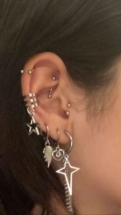 a close up of a person with ear piercings on their ears and behind the ear