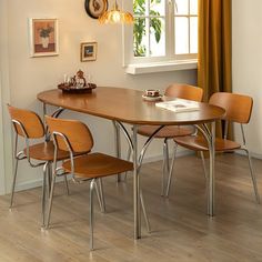 a dining room table with four chairs around it