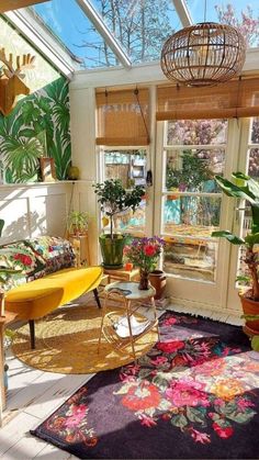 a sun room filled with lots of plants and furniture