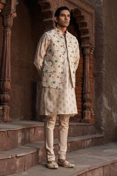 Ivory base kurta with mughal floral prints. Paired with a churidar. Comes along with a bundi with mughal prints. - Aza Fashions Festive Traditional Nehru Jacket With Floral Print, Traditional Floral Print Nehru Jacket, Wedding Nehru Jacket With Printed Motifs For Festivals, Traditional Wedding Nehru Jacket With Floral Print, Traditional Beige Kurta With Floral Print, Traditional Nehru Jacket With Printed Motifs For Wedding, Wedding Sherwani With Printed Motifs In White, Festive White Nehru Jacket With Floral Print, Wedding Sherwani With Printed Motifs