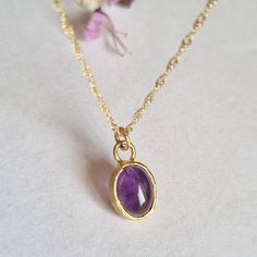 "Beautiful oval amethyst boho pendant necklace, minimalist jewelry for women, available in 14k gold plating, sterling silver, and 9k or 14k solid yellow gold. This regal necklace is solid gold and has an oval solid gold pendant. The pendant is set with an oval amethyst with a deep purple color. It is available in a high-quality 14k gold plating pendant with a gold-filled necklace, sterling silver, and 9k or 14k solid yellow gold, and in 16\" and 18\" lengths.  This necklace makes a great birthday gift for women born in February, as amethyst is the month's birthstone. This necklace is simply breathtaking. It is delicate and romantic yet striking and meaningful. You can wear it as a single item or layered with other necklaces for a total boho-chic look. It will accompany you for many years t Minimalist Oval Pendant Necklace As Gift For Her, Minimalist Gemstone Necklace With Oval Pendant, Dainty Oval Pendant Gemstone Jewelry, Dainty Oval Gemstone Pendant Jewelry, Handmade Dainty Oval Pendant Jewelry, Minimalist Oval Pendant Birthstone Necklace, Minimalist Birthstone Oval Pendant Necklace, Minimalist Birthstone Necklace With Oval Pendant, Oval Amethyst Birthstone Necklaces