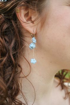 These are potentially my favorite earrings of all time.... I seriously LOVE THEM. Featuring clay flowers, hand sculpted in our studio, 18k white gold filled chain, and perfect little huggie hoops. These earrings are to die for! Each pair is 2.25 inches in length and incredibly lightweight and comfortable to wear all day long. Plus each huggie hoop is also made with stainless steel so it's the best of the best out there for even the most sensitive ears. This earring is constantly a customer favor Flowers White, Clay Flowers, Flower Clip, Handmade Clay, Needle Art, 50th Gifts, Blue Rose, Sensitive Ears, Wisteria