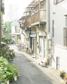 an alley way with several balconies and bicycles parked on the side