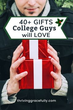 a man holding a red gift box with the words 40 + gifts college guys will love