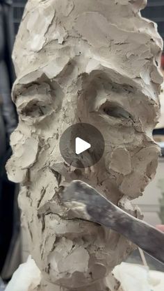 a clay face being made with a knife