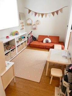 a living room filled with furniture and a white rug on top of a hard wood floor