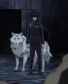 a man standing next to two white wolfs