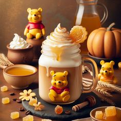 a winnie the pooh mug with whipped cream and honey on it, surrounded by other items