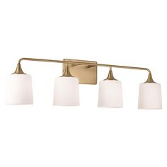 three light bathroom fixture with white shades on the sides and gold finish, in an old - fashioned style