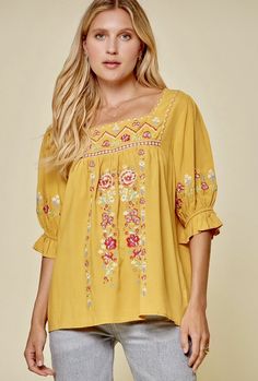 Add a little sunshine into your day! Mary Marigold Embroidered Blouse Cute embroidery top featuring square shaped neckline and half sleeves. Babydoll bodice with beautiful embroidery all over. Woven & Non Sheer Rayon Cotton Floral Embroidery Square Neck Top, Embroidered Square Neck Top For Summer, Cotton Top With Floral Embroidery And Square Neck, Cotton Tops With Floral Embroidery And Square Neck, Square Neck Cotton Top With Floral Embroidery, Peasant Style Square Neck Blouse For Spring, Spring Floral Embroidered Half Sleeve Top, Spring Bohemian Blouse With Square Neck, Spring Bohemian Square Neck Blouse