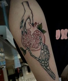 a person with a tattoo on their arm holding a heart