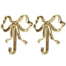 pair of gold bow earrings on white background