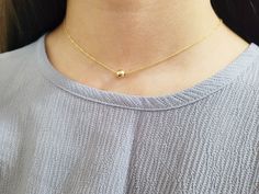 Add a touch of elegance with this simple delicate necklace featuring a dainty Gold Filled Ball floating on a chain. This simple floating necklace is the perfect finishing piece to any outfit. Wear it alone or layered with other necklaces. A great everyday necklace to add to your collection. The gold ball on this necklace is mobile and moves around the chain, turning it into the perfect dainty fidget necklace. Makes a great gift to add to any gemstone lover's collection. Perfect to gift for Chris Minimalist Layered Necklace With Adjustable Chain, Minimalist Layered Choker Necklace, Dainty Station Necklace With Adjustable Chain As Gift, Simple Necklace With Delicate Chain For Gift, Delicate Everyday Necklaces With Simple Design, Simple Necklace With Delicate Chain For Layering, Simple Delicate Chain Necklace For Gift, Delicate Simple Necklaces For Everyday, Simple Delicate Chain Necklace For Layering