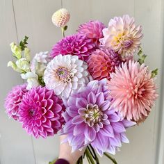 a person holding a bouquet of flowers in their hand