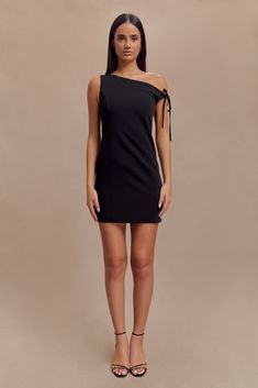 Timeless redesign. The BAKER Suiting Off Shoulder Dress is a perfect blend of modern sophistication and timeless elegance. This mini dress features an asymmetrical neckline and a drop shoulder design, highlighted by a chic shoulder tie detail for added flair. The contour panel lines create a flattering silhouette, while the side zip closure ensures a seamless fit. With its mini length, the Baker dress offers a stylish and polished look, ideal for any upscale event or evening out. Asymmetrical Neckline, Shoulder Design, Polished Look, Drop Shoulder, Side Zip, Latest Fashion Trends, Off Shoulder Dress, Timeless Elegance, Latest Fashion