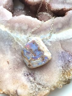 "A raw piece of genuine Opal was made into a Opal pendent and strung on a dainty 16\" strong Sterling silver chain. This pendent is so unique and absolutely beautiful. Perfect gift for an October birthday. This is the necklace you will receive Purple Opal with multi colors The Opal is one of the most beautiful stones to see 💙 The stone inspires Hope Love Purity Luck Happiness Handcrafted Raw Opal Gemstone Pendant Necklace *Raw stones offer stunning unique characteristics *Soothing shades of Pur Unique Sterling Silver Necklace With Raw Stone, Sterling Silver Pendant Necklace With Raw Stone, Raw Stone Pendant Necklace In Amulet Style, Unique Raw Stone Pendant Necklaces, Opal Gemstone Pendant Necklace, Opal Pendant Necklace With Large Pendant, Artisan Silver Necklace With Raw Stone, Elegant Sterling Silver Necklace With Raw Stone, Opal Necklace With Natural Stones As Gift