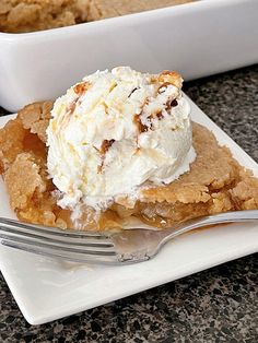 a piece of pie sitting on top of a white plate with a fork next to it